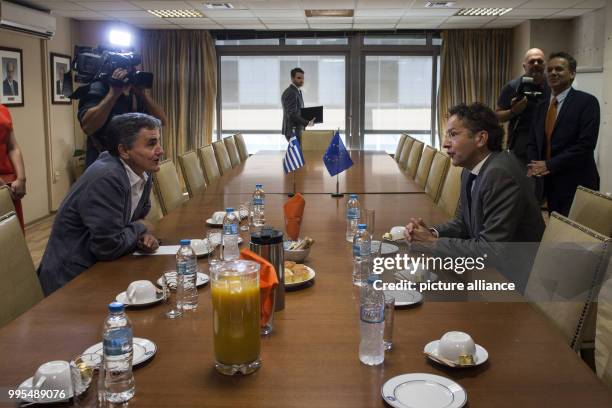 Jeroen Dijsselbloem, President of the Eurogroup, and Euclid Tsakalotos, Greek minister of the finances, speak at a meeting in the Greek ministry of...