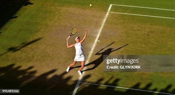 Slovakia's Daniela Hantuchova serves in her doubles match with France's Marion Bartoli on the eighth day of the 2018 Wimbledon Championships at The...