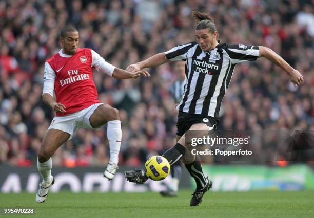 Gael Clichy of Arsenal attempts to tackle Andy Carroll of Newcastle United during a Barclays Premier League match at the Emirates Stadium on November...