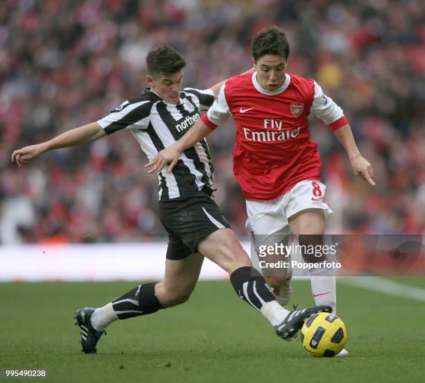 Samir Nasri of Arsenal is tackled by Joey Barton of Newcastle United during a Barclays Premier League match at the Emirates Stadium on November 7,...
