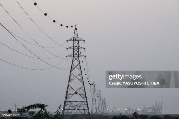 Picture shows electric lines connected to the Doraleh Container Terminal in Djibouti, on July 4, 2018. East Africa's smallest country Djibouti...