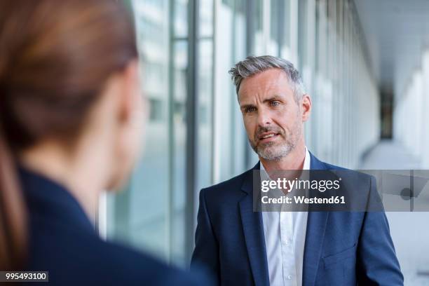 portrait of sceptical businessman face to face to his business partner - suspicion stock-fotos und bilder