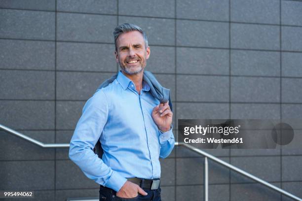 portrait of content businessman wearing light blue shirt - powder blue shirt stock pictures, royalty-free photos & images
