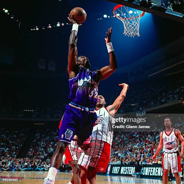 Karl Malone of the Utah Jazz shoots a layup against Charles Barkley of the Houston Rockets in Game Four of the Western Conference Finals during the...