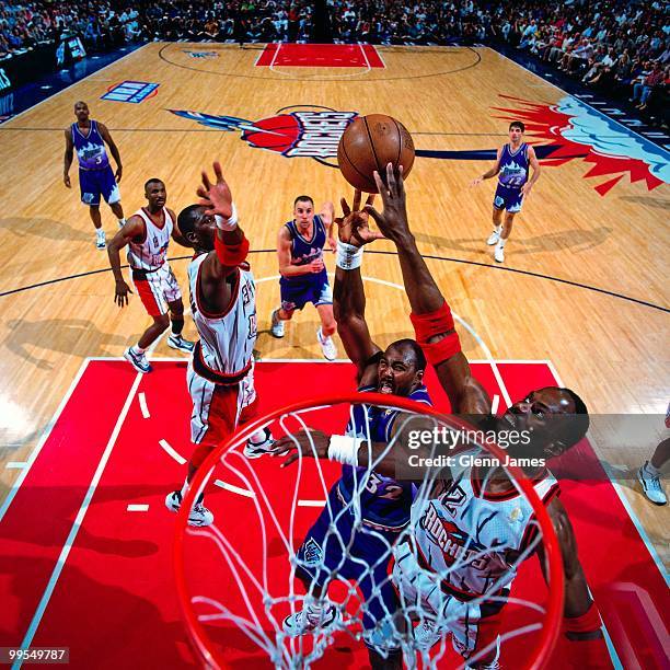 Karl Malone of the Utah Jazz shoots against Kevin Willis of the Houston Rockets in Game Four of the Western Conference Finals during the 1997 NBA...