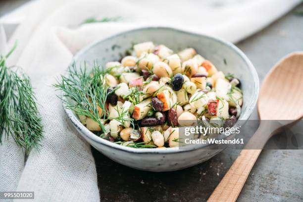 bean salad, with black beans, chickpea, apple, spring onion and dill - eetgerei stockfoto's en -beelden