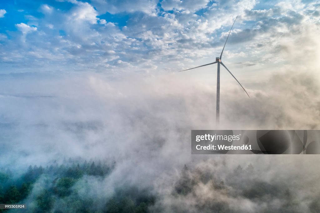 Germany, Baden-Wuerttemberg, Schurwald, Aerial view of wind wheel and morning fog