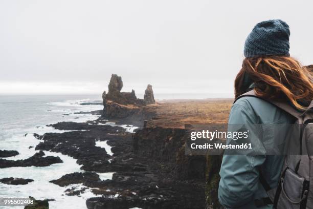 iceland, snaefells, national park snaefellsjoekull, londrangar, back view of woman looking at coast - west central iceland stock pictures, royalty-free photos & images