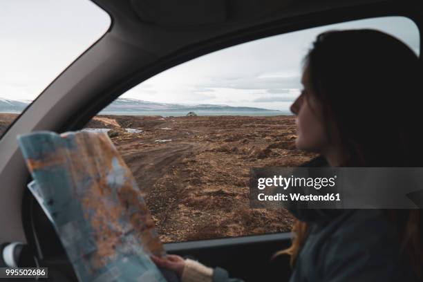 iceland, young woman in car looking out of window - car interior side stock pictures, royalty-free photos & images