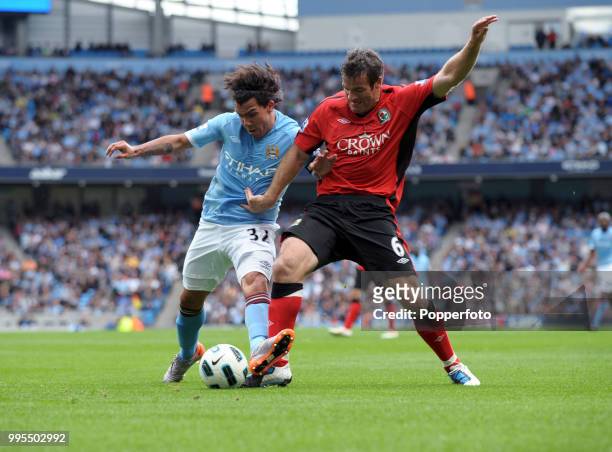 Carlos Tevez of Manchester City and Ryan Nelsen of Blackburn Rovers battle for the ball during a Barclays Premier League match at the City of...