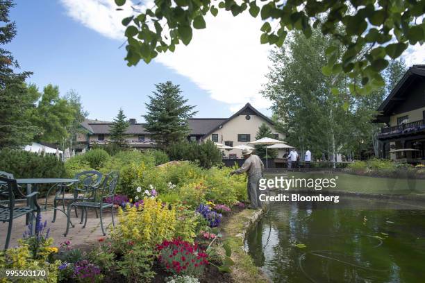 Gardener waters flowers in front of the Sun Valley Inn in Sun Valley, Idaho, U.S., on Tuesday, July 10, 2018. The 35th annual Allen & Co. Conference...