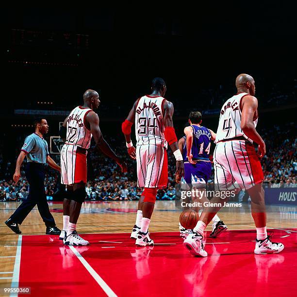 Clyde Drexler, Hakeem Olajuwon and Charles Barkley of the Houston Rockets walks off the court against the Utah Jazz in Game Four of the Western...