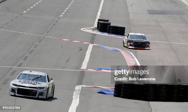 Chase Elliott leads Kasey Kahne through the backstretch during testing on The Roval at Charlotte Motor Speedway on July 10, 2018 in Charlotte, North...