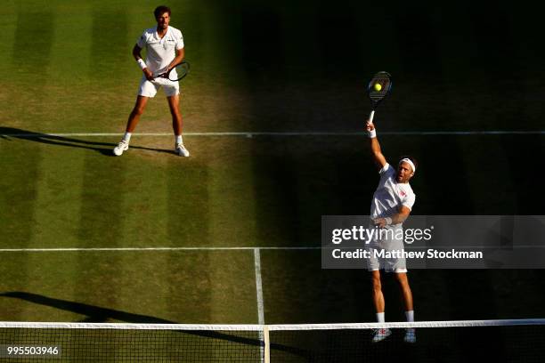 Robin Haase of the Netherlands and Robert Lindstedt of Sweden talk tactics against Dominic Inglot of Great Britain and Franko Skugor of Croatia...