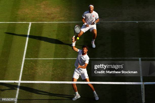 Robin Haase of the Netherlands and Robert Lindstedt of Sweden talk tactics against Dominic Inglot of Great Britain and Franko Skugor of Croatia...