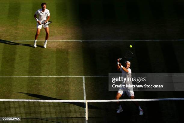 Robin Haase of the Netherlands and Robert Lindstedt of Sweden talk tactics against Dominic Inglot of Great Britain and Franko Skugor of Croatia...