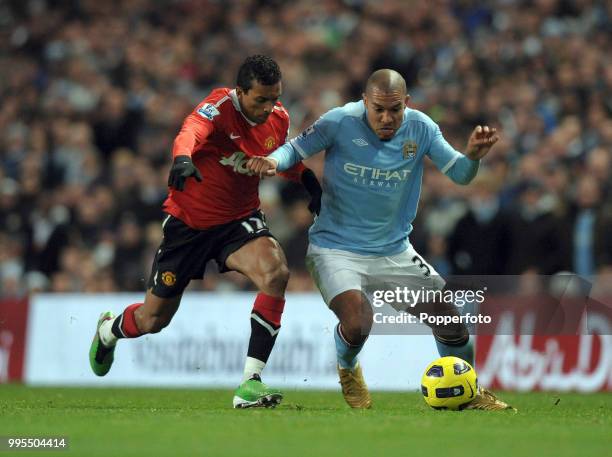 Nigel de Jong of Manchester City is challenged by Nani of Manchester United during a Barclays Premier League match at the City of Manchester Stadium...