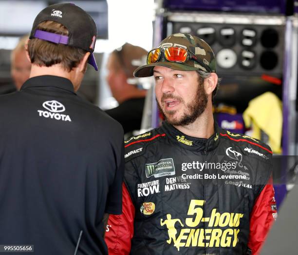 Martin Truex, Jr. Talks with crew members before testing for The Roval at Charlotte Motor Speedway on July 10, 2018 in Charlotte, North Carolina.