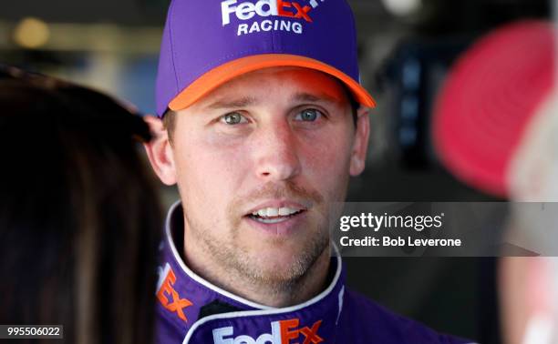 Denny Hamlin huddles in the garage during testing at The Roval at Charlotte Motor Speedway on July 10, 2018 in Charlotte, North Carolina.