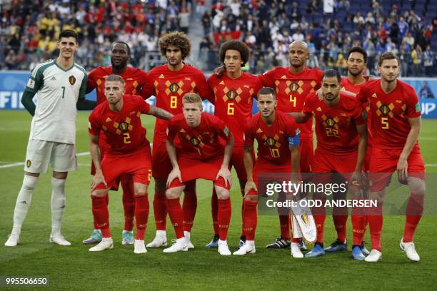 Belgium's players goalkeeper Thibaut Courtois, forward Romelu Lukaku, midfielder Marouane Fellaini, midfielder Axel Witsel, defender Vincent Kompany,...