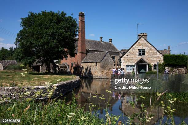 Lower Slaughter in The Cotswolds, United Kingdom. Lower Slaughter village is built on both banks of the River Eye, a slow-moving stream, crossed by...