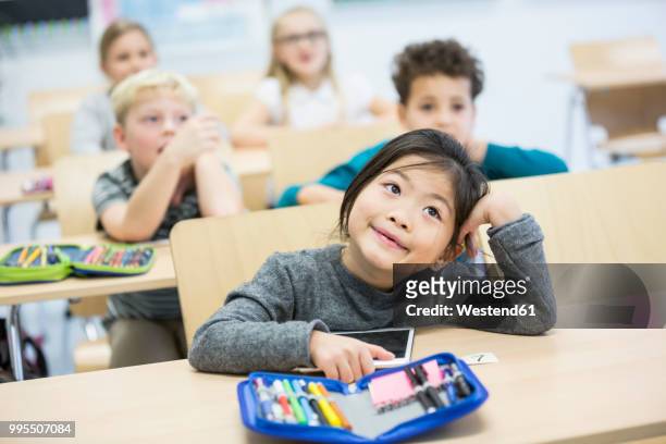 portrait of schoolgirl with classmates in class - pencil case stock pictures, royalty-free photos & images