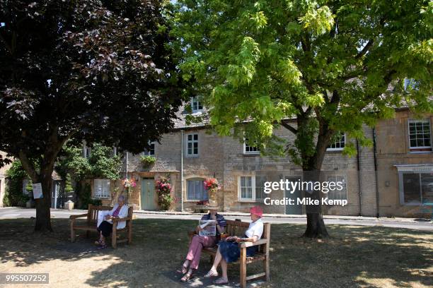 Reading the newspaper in Stow on the Wold in The Cotswolds, United Kingdom. Stow-on-the-Wold is a small market town and civil parish in...