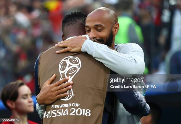 Belgium Assistant Coach, Thierry Henry, greets Steve Mandanda of France prior to the 2018 FIFA World Cup Russia Semi Final match between Belgium and...