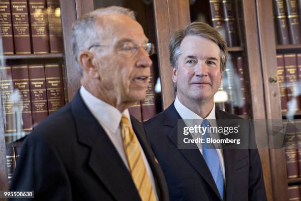 Brett Kavanaugh, U.S. Supreme Court associate justice nominee for U.S. President Donald Trump, right, listens as Senator Chuck Grassley, a Republican...