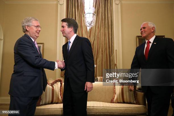 Brett Kavanaugh, U.S. Supreme Court associate justice nominee for U.S. President Donald Trump, center, shakes hands with Senate Majority Leader Mitch...