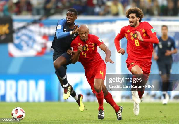Vincent Kompany of Belgium challenges Paul Pogba of France during the 2018 FIFA World Cup Russia Semi Final match between Belgium and France at Saint...