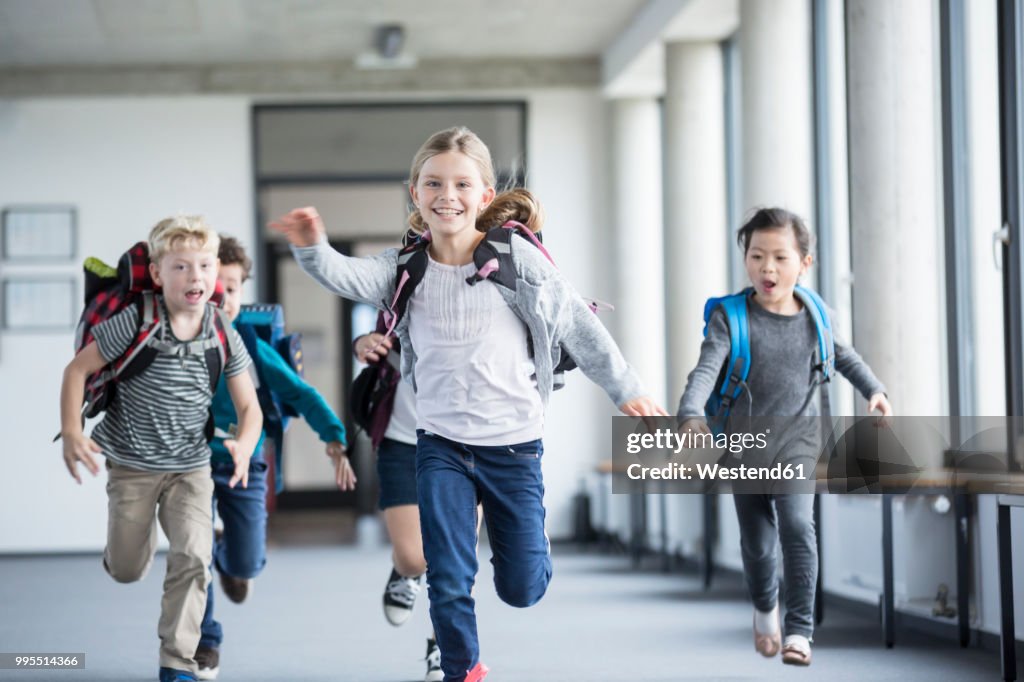 Excited pupils rushing down school corridor