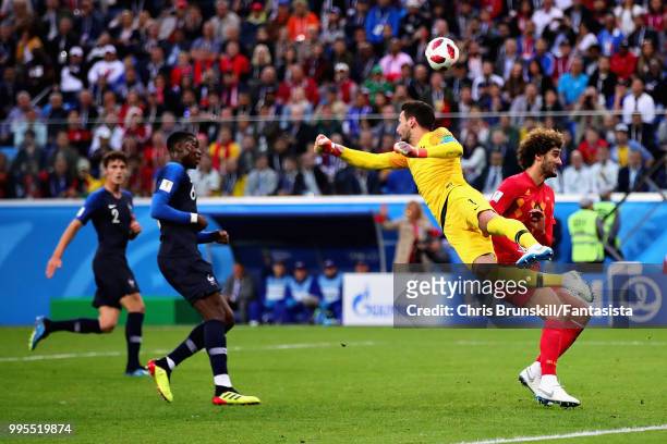 Hugo Lloris of France punches the ball as Marouane Fellaini of Belgium attempts to head it during the 2018 FIFA World Cup Russia Semi Final match...