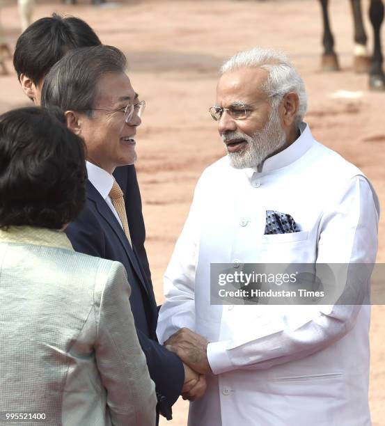 Prime Minister Narendra Modi greets South Korea's President Moon Jae-in during a ceremonial reception at the Presidential palace on July 10, 2018 in...