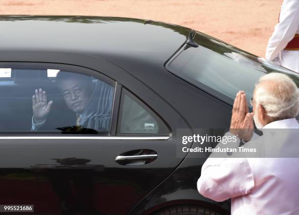 South Korean President Moon Jae-in waves to Prime Minister Narendra Modi as he leaves after attending a ceremonial reception at Presidential palace...