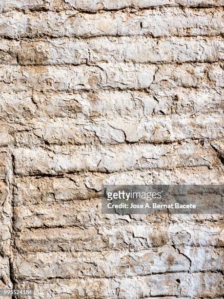 full frame of a facade of a stone wall with bricks ancient. - adobe texture stockfoto's en -beelden