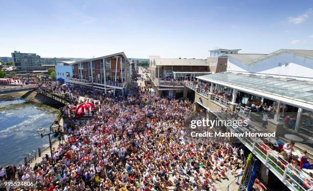 Football fans watch the World Cup quarter-final match between England and Sweden on a big screen at Mermaid Quay, Cardiff Bay, on July 07, 2018 in...