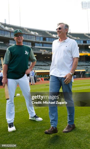 Manager Bob Melvin and Executive Vice President of Baseball Operations Billy Beane of the Oakland Athletics talk on the field after first round draft...