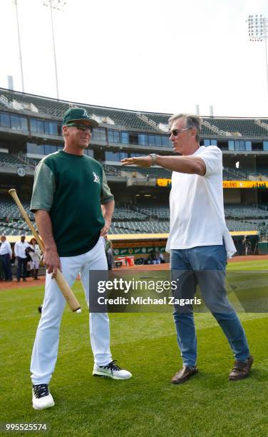 Manager Bob Melvin and Executive Vice President of Baseball Operations Billy Beane of the Oakland Athletics talk on the field after first round draft...