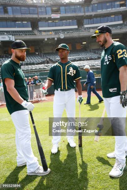 Jonathan Lucroy, first round draft pick Kyler Murray and Matt Joyce of the Oakland Athletics talk on the field after Murray signed his contact at the...