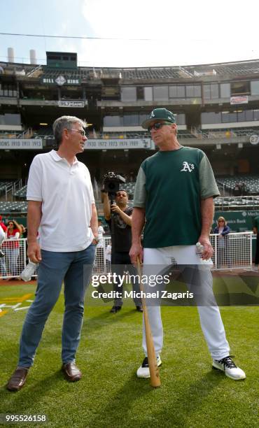 Manager Bob Melvin and Executive Vice President of Baseball Operations Billy Beane of the Oakland Athletics talk on the field after first round draft...