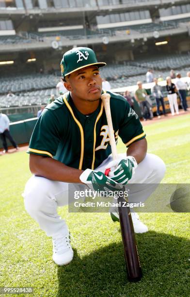 First round draft pick Kyler Murray of the Oakland Athletics kneels on the field after signing his contract at the Oakland Alameda Coliseum on June...