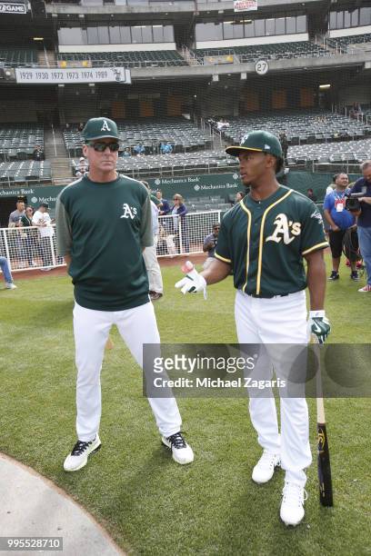 Manager Bob Melvin of the Oakland Athletics talks with first round draft pick Kyler Murray on the field after Murray signed his contract with the...