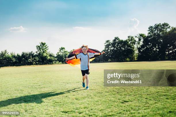 boy, enthusiastic for soccer world championship, waving german flag - soccer flags stock pictures, royalty-free photos & images