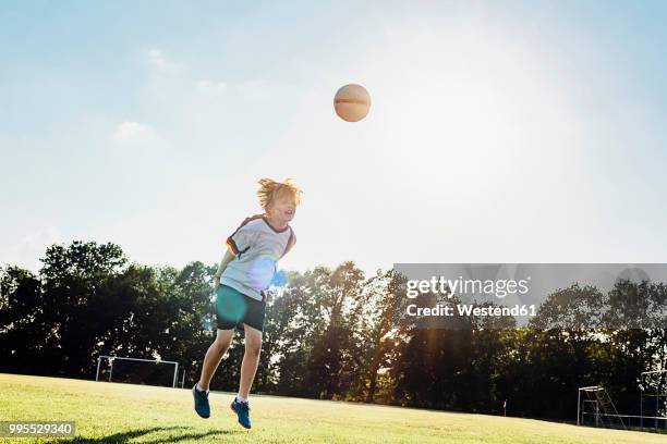 boy wearing german football shirt playing soccer - heading stock pictures, royalty-free photos & images