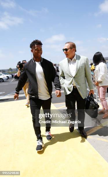 First round draft pick Kyler Murray of the Oakland Athletics and Agent Scott Boras stand outside the Oakland Alameda Coliseum before Murray signs his...