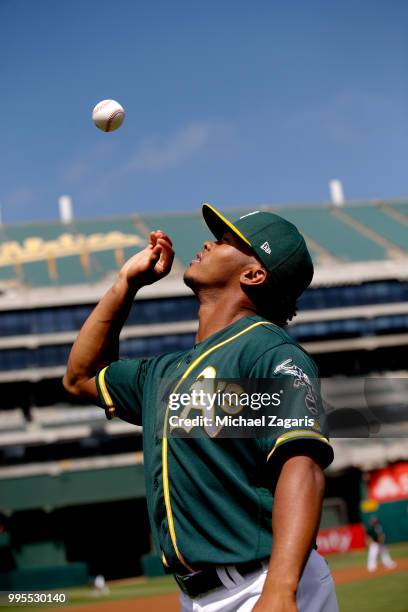 First round draft pick Kyler Murray of the Oakland Athletics goes through a photo session on the field after signing his contract at the Oakland...