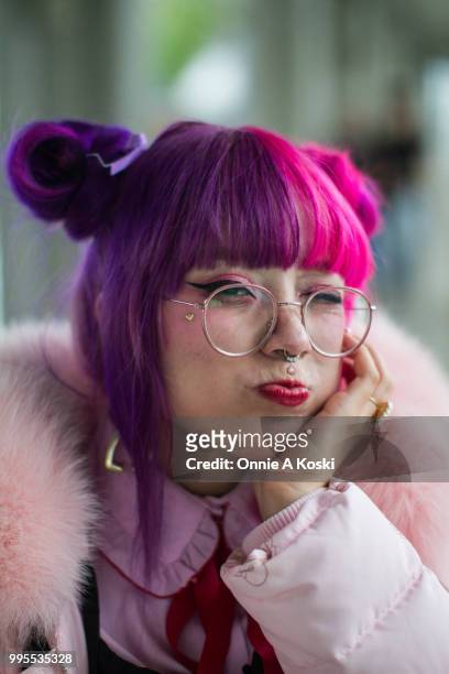 Laura Anunnaki is wearing a coat by Bonbon 21, dress by Honey Cinamon, blouse by WeGo, shoes by Vans x Lazy Oaf at Tokyo Design Festa on May 13, 2018...