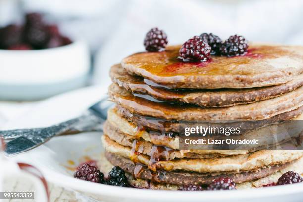 whole wheat oatmeal pancakes with blackberry and syrup - obradovic stock pictures, royalty-free photos & images