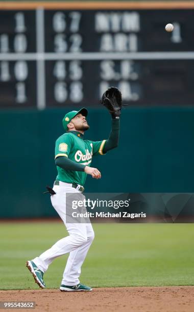Jed Lowrie of the Oakland Athletics catches a popup during the game against the Los Angeles Angels of Anaheim at the Oakland Alameda Coliseum on June...